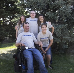 A group of people wearing Reframe Disability shirts.