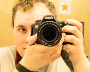 Joe Tiner holding a camera up to his face.