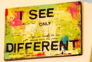 A piece of wall art that says "i see only different".